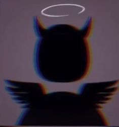 an angel with wings and halo in front of a gray background, the image appears to be blurry