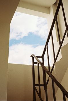 an open stairwell leading up to the sky