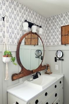 a bathroom sink sitting under a large mirror