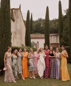 a group of women standing next to each other on top of a lush green field