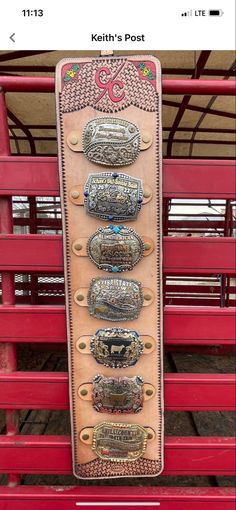 a red bench with a bunch of belt buckles on it's back side