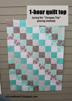 a blue and white quilt hanging on the side of a building with text overlay that reads, 1 - hour quilt top using the scrappy trip piecing method