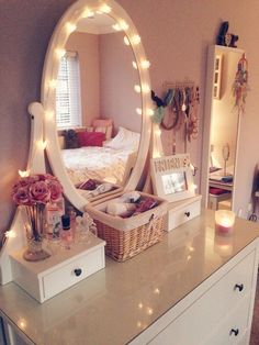 a mirror sitting on top of a dresser next to a white dresser topped with drawers