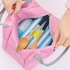 a person holding a pink bag with utensils in it