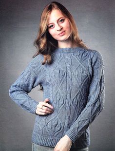 a woman is posing for the camera wearing a sweater