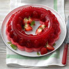 a strawberry jelly cake on a white plate