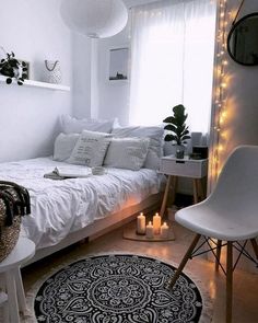 a bedroom with white walls and lights on the ceiling is decorated in black and white