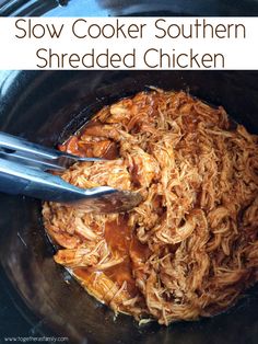 slow cooker southern shredded chicken in a crock pot with tongs on the side