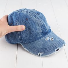 Light Denim Ripped Look Hat. Whether you are wanting a hat to dress up, or just to simply keep the sun out of your eyes this Light Denim Ripped Look Hat is just right for you. Trendy Distressed Visor Baseball Cap, Trendy Washed Baseball Cap, Trendy Distressed Dad Hat With Curved Brim, Denim Blue Baseball Cap For Spring, Trendy Washed Snapback Hat, Trendy Curved Brim Distressed Dad Hat, Distressed Medium Wash Adjustable Hat, Trendy Distressed Visor Hat, Trendy Distressed Adjustable Dad Hat