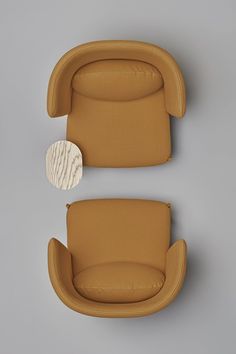 an image of a couch and chair set up on the wall with a round wooden table