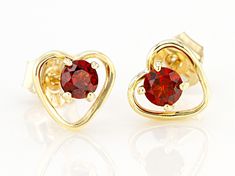 Pre-Owned .26ctw Round Vermelho Garnet™ Solitaire, Child's 10k Yellow Gold Heart Stud Earrings. Measure approximately .23"L x .25"W. Push backs..  This product may be a customer return, vendor sample, or on-air display and is not in its originally manufactured condition.  It may not be new.  In some instances, these items are repackaged by JTV. January Baby, Gold Heart Stud Earrings, Gold Heart Studs, Heart Stud Earrings, Broken Chain, Pearl Strands, Heart Studs, Garnet Gemstone, Heart Earrings Studs