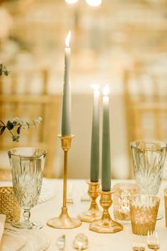 the table is set with candles and place settings