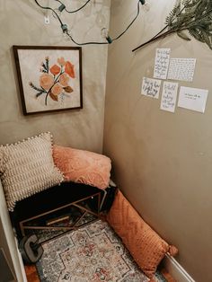 a room with a chair, rug and pictures on the wall