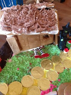 a cake that looks like it has been made to look like a box with gold coins