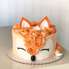 a close up of a cake with an animal face on it's frosting