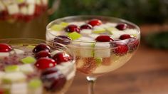 two wine glasses filled with fruit and ice