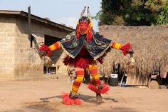 a person in costume standing on dirt ground