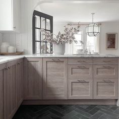 a kitchen with wooden cabinets and marble counter tops