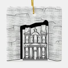 an ornament with a drawing of a building on the side of a wall