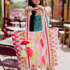 Introducing the pink red swirls with neon pom poms tote bag from Katydid Wholesale - a fusion of elegance and vibrancy designed to entice your discerning clientele. This captivating tote embodies the essence of bohemian charm, making it a perfect addition to the inventory of your boutique. The multicolored swirls, meticulously embellished with sequins, create a captivating visual journey on the canvas. Enhanced with intricate boho embroidery, this tote is a wearable work of art that speaks volum Yellow Champagne, Kids Scarf, Strawberry Print, Tote Bag Purse, Sequin Beading, Wholesale Beads, Large Tote Bag, Checkered Pattern, Beautiful Embroidery