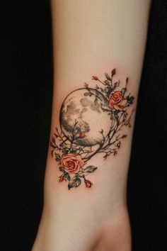 a woman's wrist with roses and a moon on it