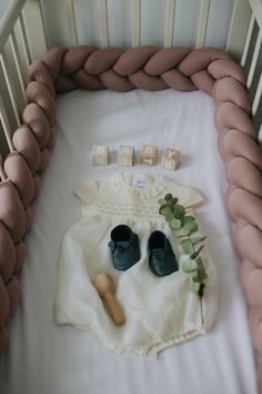 a baby's crib with shoes and toys on it