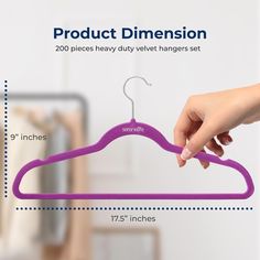 a woman's hand holding a purple hanger with the measurements for each piece