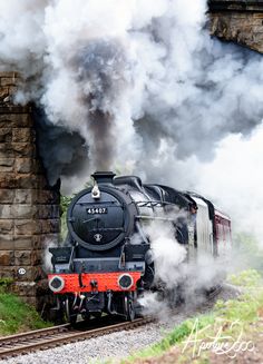 a steam train is coming down the tracks