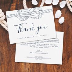 two wedding thank cards tied together with twine on top of a wooden table next to rope