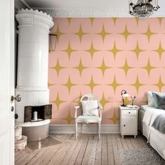 a bedroom with pink and yellow wallpaper, white furniture and a chandelier