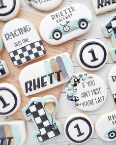 decorated cookies with numbers and race cars on top of a wooden table next to each other