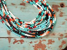 Navajo Style Seed Bead Necklace - Western Themed in Turquoise, White, or Black with Gradient Sunset Colors Description: Elevate your style with our Navajo Style Seed Bead Necklace, perfect for adding a touch of the native western vibe to your wardrobe. Available in three stunning main colors--turquoise, white, or black--each necklace features a beautiful gradient of sunset colors that perfectly complements the main shade, creating a striking and vibrant look. Details: - Length: 15 inches with an Handmade Western Multicolor Beaded Necklaces, Handmade Multicolor Western Beaded Necklaces, Handmade Multicolor Western Beaded Necklace, Gradient Sunset, Cowgirl Necklaces, Beautiful Gradient, Seed Bead Choker, Cowgirl Look, Steer Skull