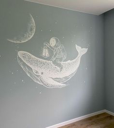 a child's room painted with a mural of a boy on a whale and the moon