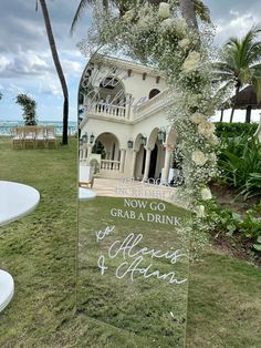 a glass sign that says, now go grand drink to cheers and friends on the lawn