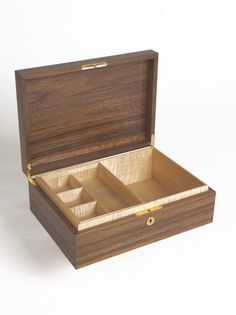 an open wooden box with three compartments