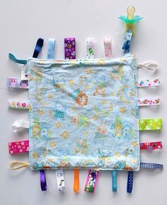 an assortment of colorful hair clips laid out on top of a white surface with a blue background