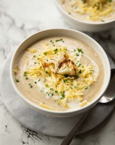 two bowls filled with creamy roasted cauliflower soup