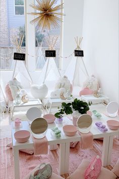 a room filled with lots of white and pink furniture