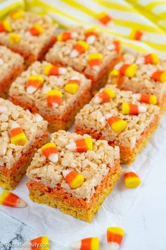 candy cornbread rice krispy treats stacked on top of each other in front of candy cornflakes