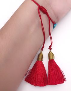 "Miyuki Bracelet Details: Handmade Woven Bracelet Adjustable from 5\" inches to 10\" inches Dimensions: 3.5\" x 0.75\" or 8.5 cm x 1.8 cm 2\" Red Silk Tassels. The tassels are wrapped with brass wire. This is a trendy piece to wear alone or with other bracelets. Each item is carefully shipped in a beautiful organza pouch, bubble wrapped and well protected." Red Tasseled Jewelry As A Gift, Red Tasseled Jewelry For Gift, Adjustable Beaded Bracelets With Tassels For Beach, Traditional Red Friendship Bracelets For Beach, Adjustable Tassel Jewelry For The Beach, Adjustable Tassel Jewelry For Beach, Adjustable Red Jewelry With Tassels, Adjustable Red Jewelry With Latkans, Adjustable Red Tasseled Jewelry