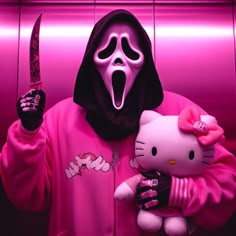 a hello kitty doll holding a knife and wearing a pink hoodie with a skull on it