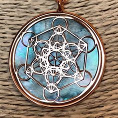 "Metatron in rose gold on 925 silver and blue mother of pearl backdrop The cube known as Metatron takes name by the same Archangel, known as God's scribe. It contains every shape that exists in the universe God has created combining male and female aspects. Within the cube thirteen spheres of female eneregy lies drawing the Fruit of Life, in the middle of which male straight lines are irradiated. In its shapes a triangle and two cubes are also created by six line started from the middle. It also Spiritual Round Mother Of Pearl Jewelry, Mother Of Pearl Jewelry With Large Pendant As Gift, Mother Of Pearl Large Pendant Jewelry Gift, Mother Of Pearl Pendant Jewelry As Gift, Engraved Mother Of Pearl Jewelry Gift, Engraved Mother Of Pearl Jewelry For Gift, Star Of David Amulet Jewelry For Gift, Lies Drawing, Pearl Backdrop