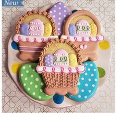 three decorated cookies sitting on top of a plate