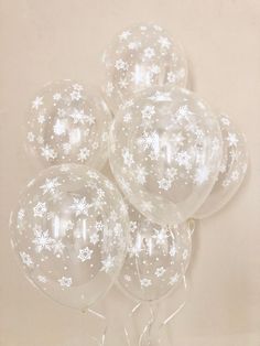 clear snowflake balloons with white stars on them