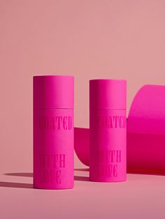 two pink cups sitting next to each other on top of a pink surface with the words whatever is fine written on them