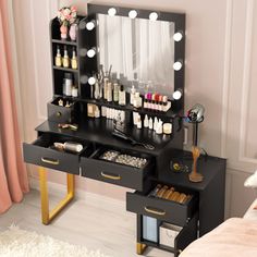 a black vanity with lights and drawers in a bedroom next to a pink curtained window