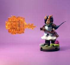 a lego figurine with an orange object in front of it on a purple background