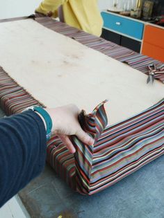 a person is wrapping fabric on top of a table