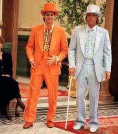 two men in orange suits and hats standing next to each other