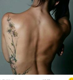 the back of a woman's body with flowers on it